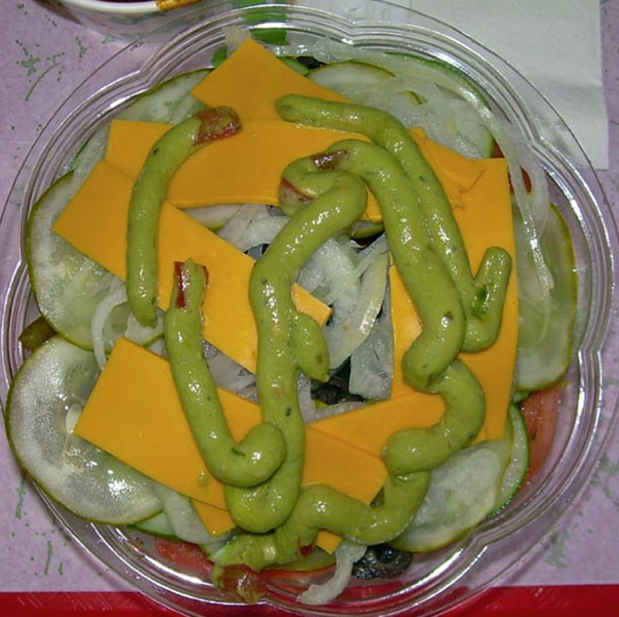 Vegetable salad with cheese and guacamole “worms”
