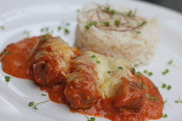 Baked Cevapcici with Serbian Sauce and Cheese