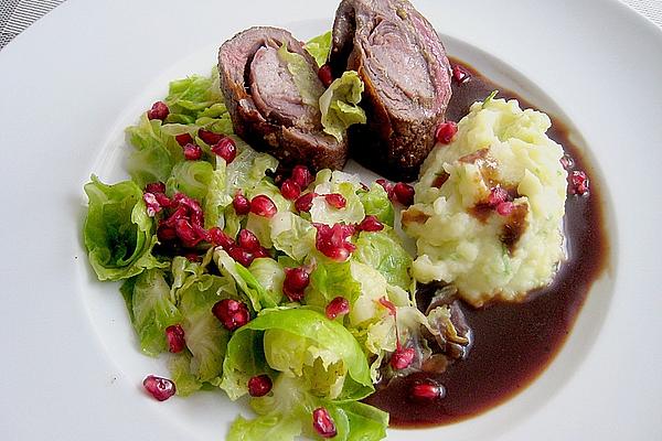 Beef Roulades Cut from Fillet with Brussels Sprouts Leaves and Pomegranate Seeds