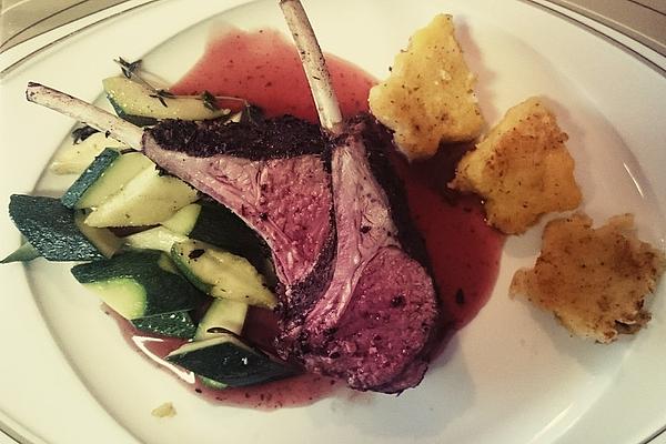Black Rack Of Lamb on Zucchini Vegetables and Tomatoes – Almond – Polenta