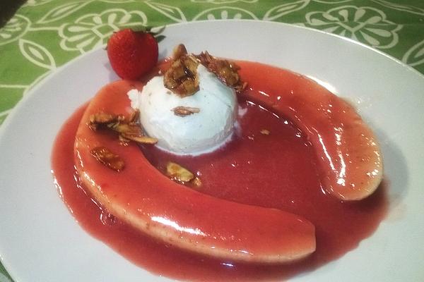 Flambéed Bananas on Vanilla Ice Cream in Strawberry Sauce