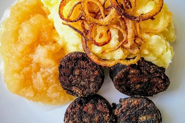 Fried Black Pudding on Mashed Potatoes with Applesauce and Fried Onions