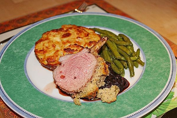 Herbal Rack Of Lamb on Onion Confit with Green Beans and Potato Gratin