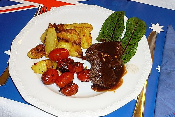 Kangaroo Fillet with Plum Sauce, Braised Cherry Tomatoes and Potato Wedges
